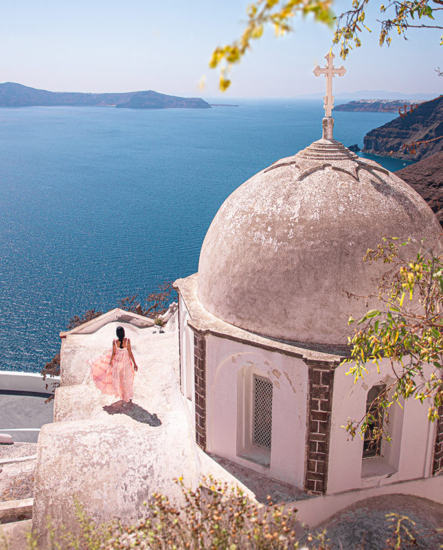 Anna Myrha in Thera, Santorini in one of the best photo spots for Instagram in Santorini, at the Church of Aghios Ioannis Theologos of Fira