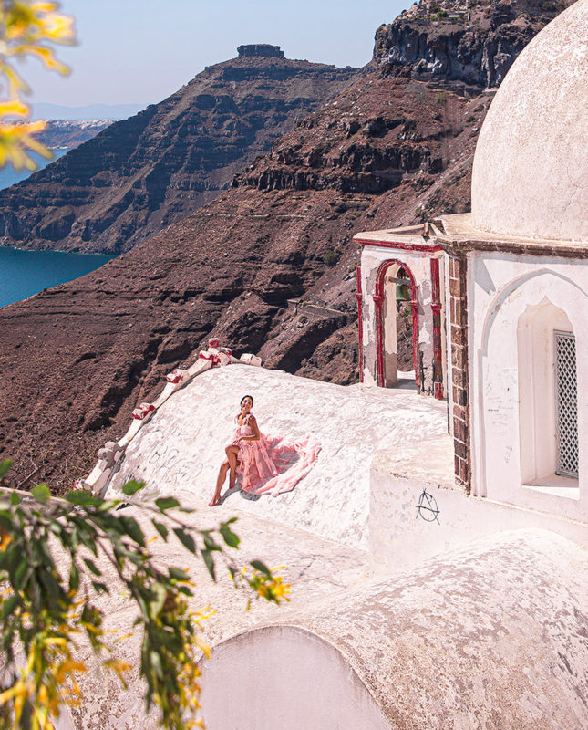 Anna Myrha in Thera, Santorini in one of the best photo spots for Instagram in Santorini, at the Church of Aghios Ioannis Theologos