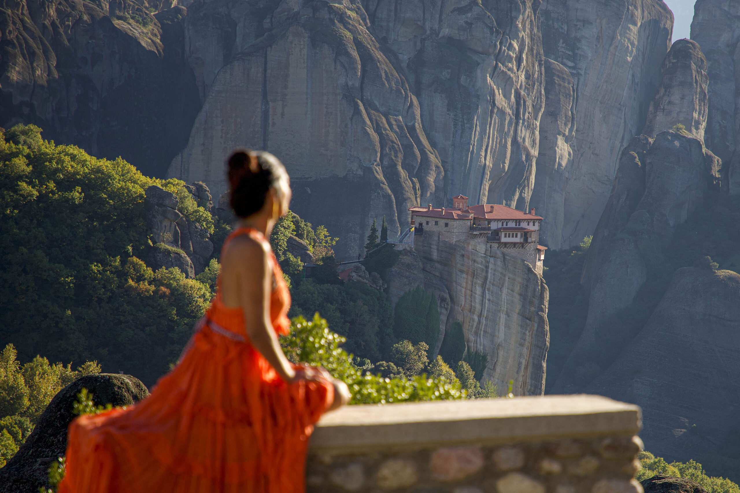 Anna Myrha staring at a Monastery at Meteora, kalabaka Greece in one of the most instagramable locations